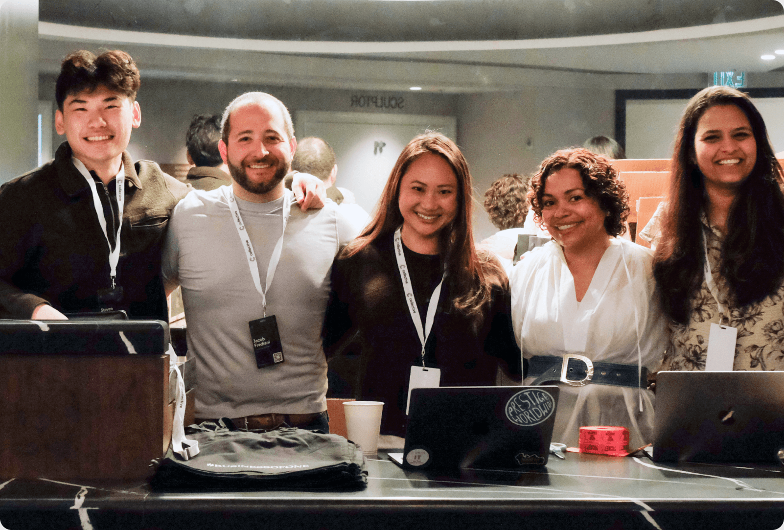 Collective team members smiling together at an event