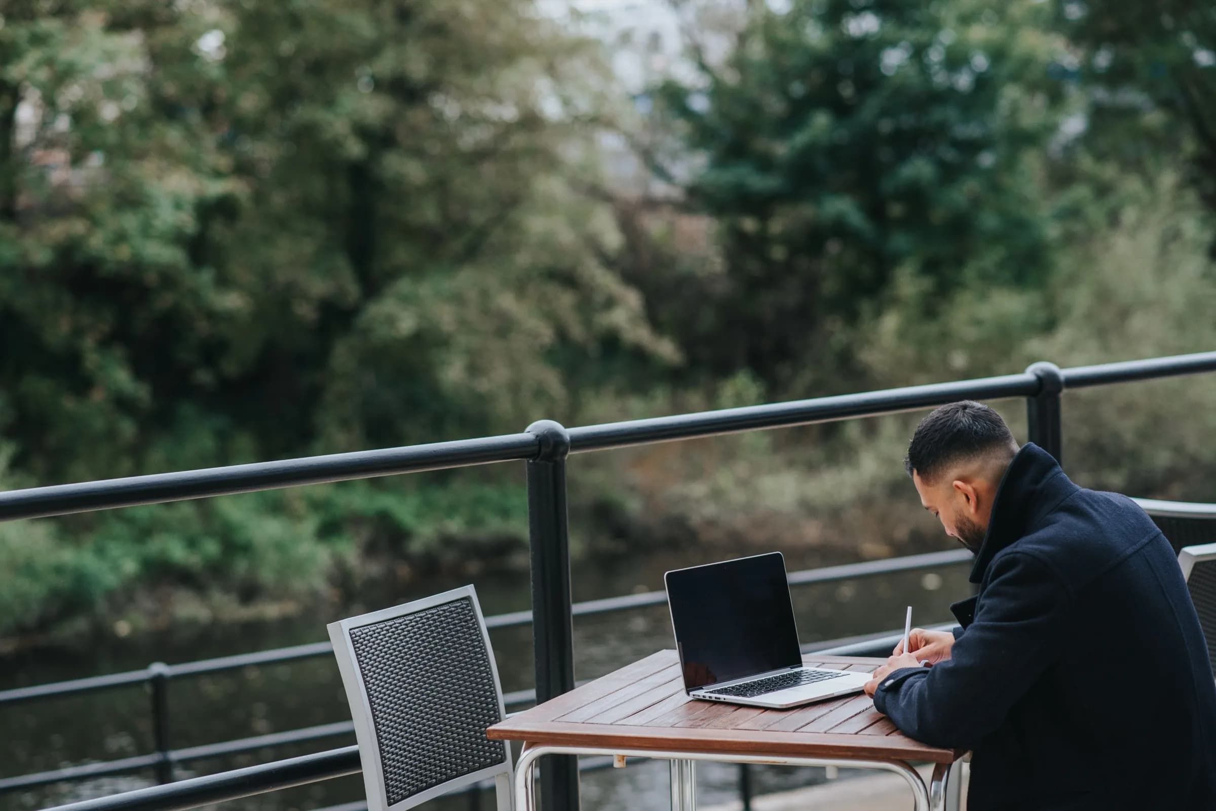 Self-employed business owner working on a laptop outdoors