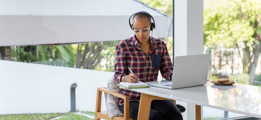 Freelancer working at laptop with headphones
