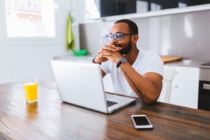 Black man working with laptop from home