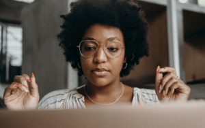 Woman wearing glasses looking at computer